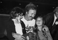 Gene Hackman with his daughters, Elizabeth and Leslie, at a Hollywood, California, celebrity baseball game (c. 1975–1985) (Image via Frank Edwards/Getty)